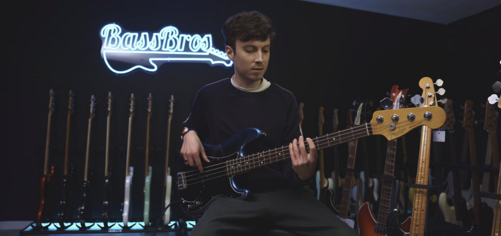 man playing bass at bassbros showroom