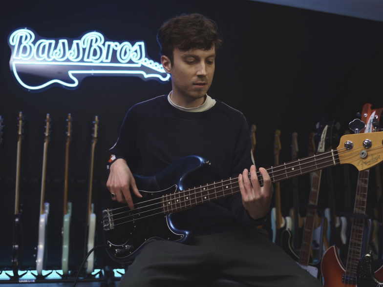 man playing bass at bassbros showroom